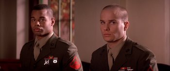 Movie still from “A Few Good Men” (1992), directed by Rob Reiner – Two men in military uniforms are standing next to each other; Close Up shot, Low angle