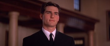 Movie still from “A Few Good Men” (1992), directed by Rob Reiner – A man in a black suit and a white tie; Close Up shot, Low angle