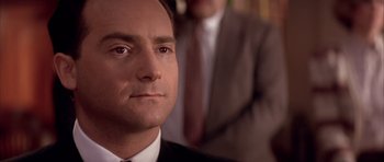 Movie still from “A Few Good Men” (1992), directed by Rob Reiner – A person wearing a suit and tie; Close Up shot, Low angle