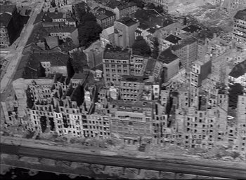 Movie still from “A Foreign Affair” (1948), directed by Billy Wilder – An aerial view of a city with many buildings; Extreme Wide shot, Overhead angle