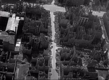Movie still from “A Foreign Affair” (1948), directed by Billy Wilder – An aerial view of a city with many buildings; Extreme Wide shot, Overhead angle