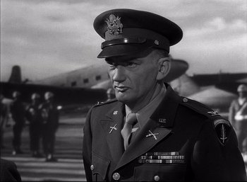 Movie still from “A Foreign Affair” (1948), directed by Billy Wilder – An old photo of a man in a military uniform; Medium shot, Low angle