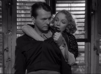 Movie still from “A Foreign Affair” (1948), directed by Billy Wilder – A man and a woman holding a knife in their hands; Medium shot, Low angle