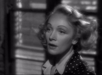 Movie still from “A Foreign Affair” (1948), directed by Billy Wilder – An old photo of a woman in a polka dot jacket; Close Up shot, Over the shoulder angle