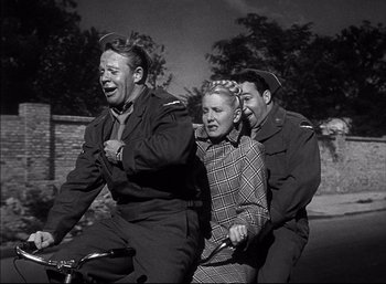 Movie still from “A Foreign Affair” (1948), directed by Billy Wilder – A group of people riding on a bicycle; Medium shot, High angle