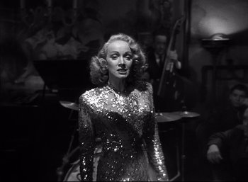 Movie still from “A Foreign Affair” (1948), directed by Billy Wilder – A black and white photo of a woman in a sequined dress; Medium shot, Low angle