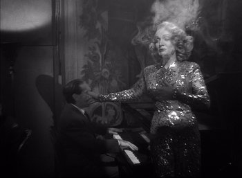 Movie still from “A Foreign Affair” (1948), directed by Billy Wilder – A woman in a sequined dress standing in front of a piano; Medium shot, Low angle