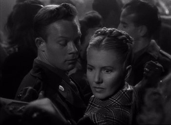 Movie still from “A Foreign Affair” (1948), directed by Billy Wilder – A man and a woman are standing in a crowd; Close Up shot, High angle