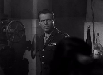 Movie still from “A Foreign Affair” (1948), directed by Billy Wilder – A man in a uniform standing in front of a mirror; Close Up shot, Low angle