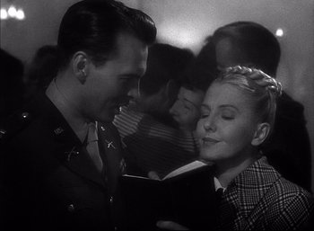 Movie still from “A Foreign Affair” (1948), directed by Billy Wilder – A man and a woman in the middle of a crowded train; Close Up shot, Low angle