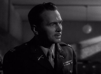 Movie still from “A Foreign Affair” (1948), directed by Billy Wilder – A man in a military uniform looking to his left; Close Up shot, Low angle