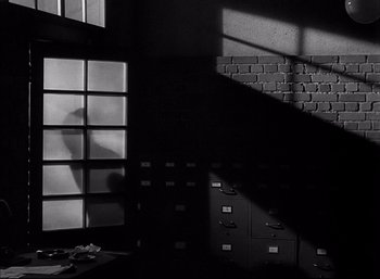 Movie still from “A Foreign Affair” (1948), directed by Billy Wilder – A black and white photo of a room with many drawers; Wide shot, Low angle