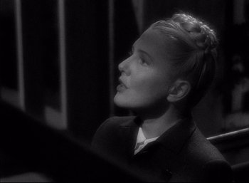 Movie still from “A Foreign Affair” (1948), directed by Billy Wilder – A young woman sitting in front of a mirror; Close Up shot, Over the shoulder angle