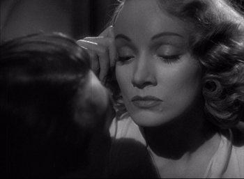 Movie still from “A Foreign Affair” (1948), directed by Billy Wilder – A black - and - white photo of a woman with her hand on her face; Close Up shot, Over the shoulder angle