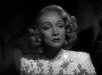 Movie still from “A Foreign Affair” (1948), directed by Billy Wilder – A black - and - white photo of a woman in a white dress; Close Up shot, Low angle