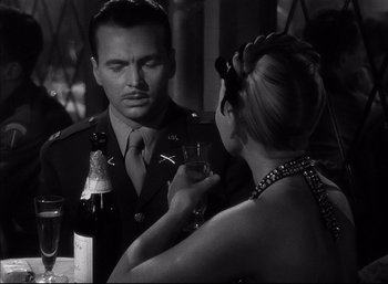 Movie still from “A Foreign Affair” (1948), directed by Billy Wilder – A man and a woman are drinking wine together; Close Up shot, Over the shoulder angle