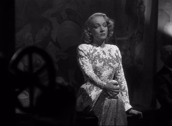 Movie still from “A Foreign Affair” (1948), directed by Billy Wilder – A black and white photo of a woman in a dress; Medium shot, Low angle