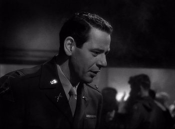 Movie still from “A Foreign Affair” (1948), directed by Billy Wilder – A black and white photo of a man in a military uniform; Close Up shot, Low angle