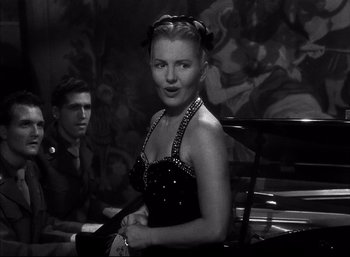 Movie still from “A Foreign Affair” (1948), directed by Billy Wilder – A young woman sitting on a bench next to a young man; Medium shot, Over the shoulder angle