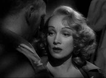 Movie still from “A Foreign Affair” (1948), directed by Billy Wilder – An old photo of marlene dietrich and a man; Close Up shot, Over the shoulder angle