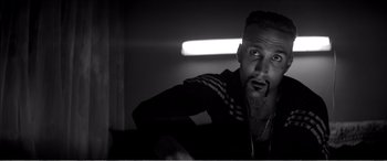 Movie still from “A Girl Walks Home Alone at Night” (2014), directed by Ana Lily Amirpour – A black and white photo of a man with a beard; Close Up shot, Low angle