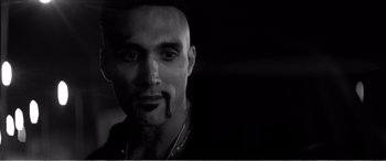 Movie still from “A Girl Walks Home Alone at Night” (2014), directed by Ana Lily Amirpour – A person with a tattoo on his face; Close Up shot, Low angle