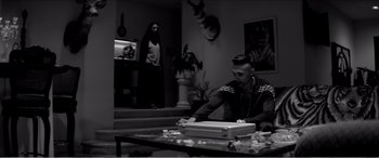 Movie still from “A Girl Walks Home Alone at Night” (2014), directed by Ana Lily Amirpour – A man sitting at a table in front of a woman; Wide shot, Over the shoulder angle