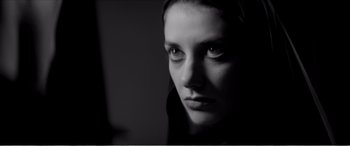 Movie still from “A Girl Walks Home Alone at Night” (2014), directed by Ana Lily Amirpour – A black - and - white photo of a woman's face; Close Up shot, Low angle