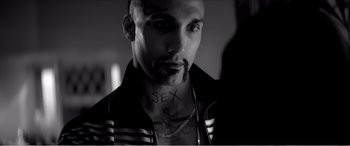 Movie still from “A Girl Walks Home Alone at Night” (2014), directed by Ana Lily Amirpour – A person wearing a jacket with sex written on it; Close Up shot, Low angle