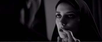 Movie still from “A Girl Walks Home Alone at Night” (2014), directed by Ana Lily Amirpour – A woman with her hand under her chin; Close Up shot, Over the shoulder angle
