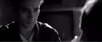 Movie still from “A Girl Walks Home Alone at Night” (2014), directed by Ana Lily Amirpour – A man in a leather jacket looking at the camera; Close Up shot, Low angle