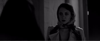 Movie still from “A Girl Walks Home Alone at Night” (2014), directed by Ana Lily Amirpour – A black and white photo of a woman looking at herself in the mirror; Close Up shot, Over the shoulder angle