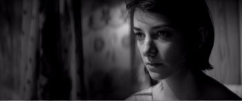 Movie still from “A Girl Walks Home Alone at Night” (2014), directed by Ana Lily Amirpour – A black - and - white photo of a woman's face; Close Up shot, Low angle
