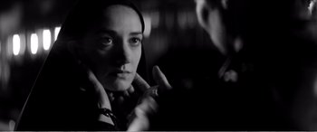 Movie still from “A Girl Walks Home Alone at Night” (2014), directed by Ana Lily Amirpour – A black - and - white photo of a woman looking into a mirror; Close Up shot, Over the shoulder angle