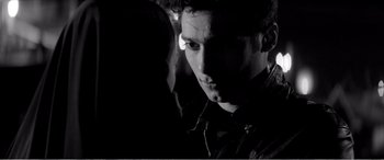 Movie still from “A Girl Walks Home Alone at Night” (2014), directed by Ana Lily Amirpour – A black and white photo of a man and a woman; Close Up shot, Over the shoulder angle