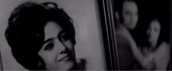 Movie still from “A Girl Walks Home Alone at Night” (2014), directed by Ana Lily Amirpour – A black - and - white photo of a woman's face; Close Up shot, Over the shoulder angle