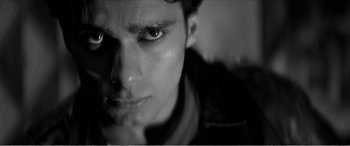 Movie still from “A Girl Walks Home Alone at Night” (2014), directed by Ana Lily Amirpour – A man's face in black and white; Extreme Close Up shot, Low angle