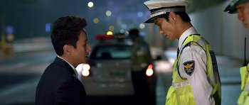 A police officer talking to a man on the side of the road