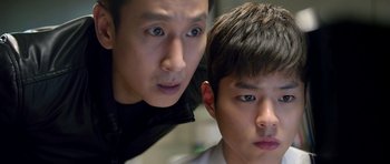 Two young men are looking at the camera