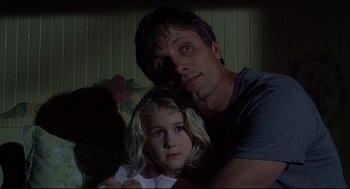 Movie still from “A History of Violence” (2005), directed by David Cronenberg – A man and a little girl pose for a picture; Close Up shot, Low angle