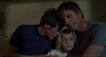 Movie still from “A History of Violence” (2005), directed by David Cronenberg – Two men and a little girl looking at each other; Close Up shot, Low angle