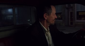 Movie still from “A History of Violence” (2005), directed by David Cronenberg – A man sitting in the back seat of a car at night; Close Up shot, Over the shoulder angle