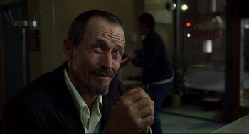 Movie still from “A History of Violence” (2005), directed by David Cronenberg – An older man sitting in front of another man; Close Up shot, Over the shoulder angle
