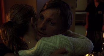 Movie still from “A History of Violence” (2005), directed by David Cronenberg – A man and a woman hugging in a room; Close Up shot, Over the shoulder angle