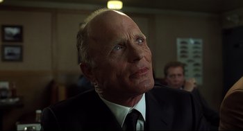 Movie still from “A History of Violence” (2005), directed by David Cronenberg – An older man wearing a suit and tie looking up; Close Up shot, Low angle