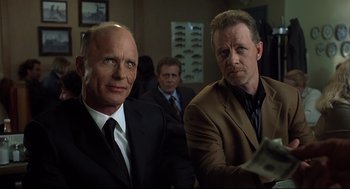 Movie still from “A History of Violence” (2005), directed by David Cronenberg – A couple of men in suits and ties in a room; Close Up shot, Low angle