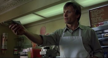 Movie still from “A History of Violence” (2005), directed by David Cronenberg – A man wearing an apron is standing in a kitchen; Close Up shot, Low angle