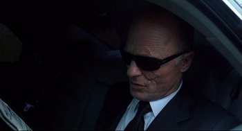 Movie still from “A History of Violence” (2005), directed by David Cronenberg – An older man wearing a suit and sunglasses; Close Up shot, Low angle