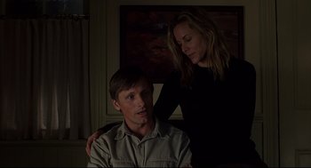 Movie still from “A History of Violence” (2005), directed by David Cronenberg – A man and a woman in a dark room; Medium shot, Low angle