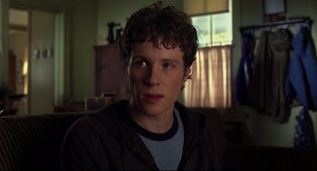 Movie still from “A History of Violence” (2005), directed by David Cronenberg – A young man is looking into the camera; Close Up shot, Low angle